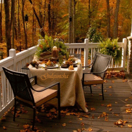Анимированная открытка Осенний лес. Терраса. Накрытый стол. Два кресла. Листопад.